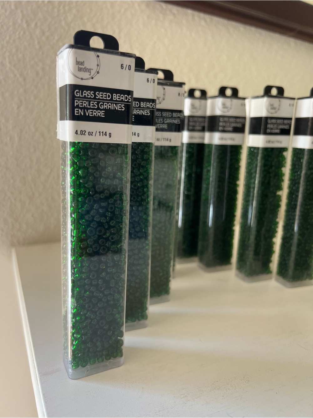 Bead landing 10 containers of dark green seed beads 6/0